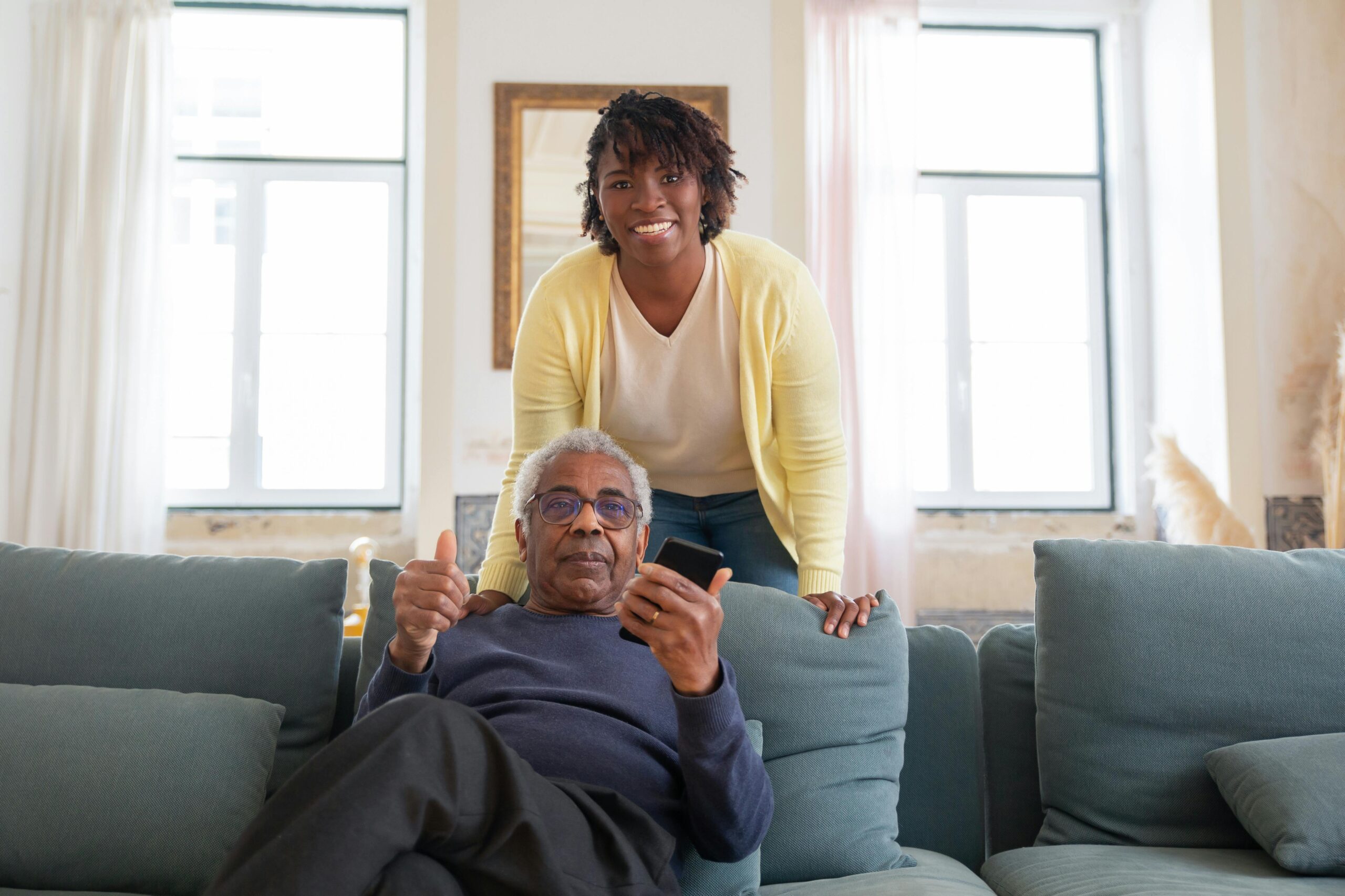 A caregiver, with a care recipient, in home care. 